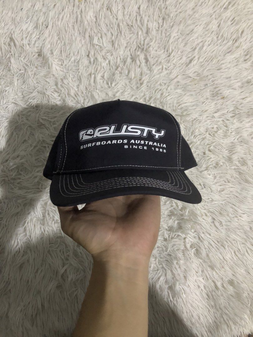Rusty Surfboards Australia Black Cap (Category: Caps & Hats) located in Tayabas. Submitted by raylee.22 (Listing ID 1449441003, Image 2). Description: - Authentic Rusty Surfboards Australia cap - Features clean white stitching detail - Subtle Rusty logo on the side - Adjustable strap for a comfortable fit - Ideal for everyday wear and outdoor adventures.