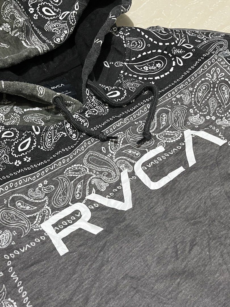 RVCA Bandana Patchwork Hoodie (Category: Coats, Jackets and Outerwear) located in Manila. Submitted by jorgemabelin2001 (Listing ID 1449364029, Image 3). Description: - Stylish RVCA hoodie with a unique bandana patchwork design. - Prominent RVCA logo on the front. - Features the 'Balance of Opposites' graphic on the back. - Includes a convenient front pocket. - Adjustable drawstrings for the hood. - Ideal for casual and everyday wear..