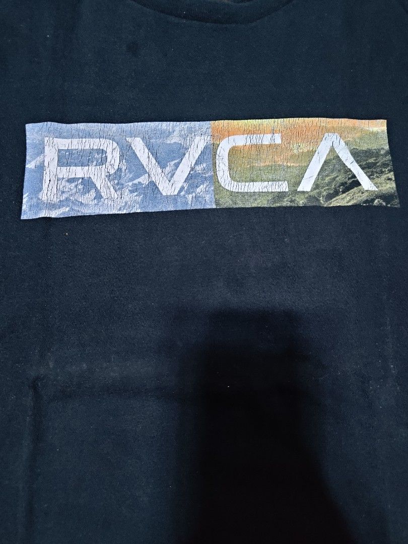 RVCA Black T-Shirt with Graphic Logo (Category: Tshirts & Polo Shirts ) located in Manila. Submitted by 3mvalkayrie (Listing ID 1449459212, Image 2). Description: - Brand: RVCA - Color: Black - Size: L - Design: Colorful RVCA logo graphic on front - Material: Good quality - Occasion: Casual wear - Special Feature: Artist Network Program details on tag.