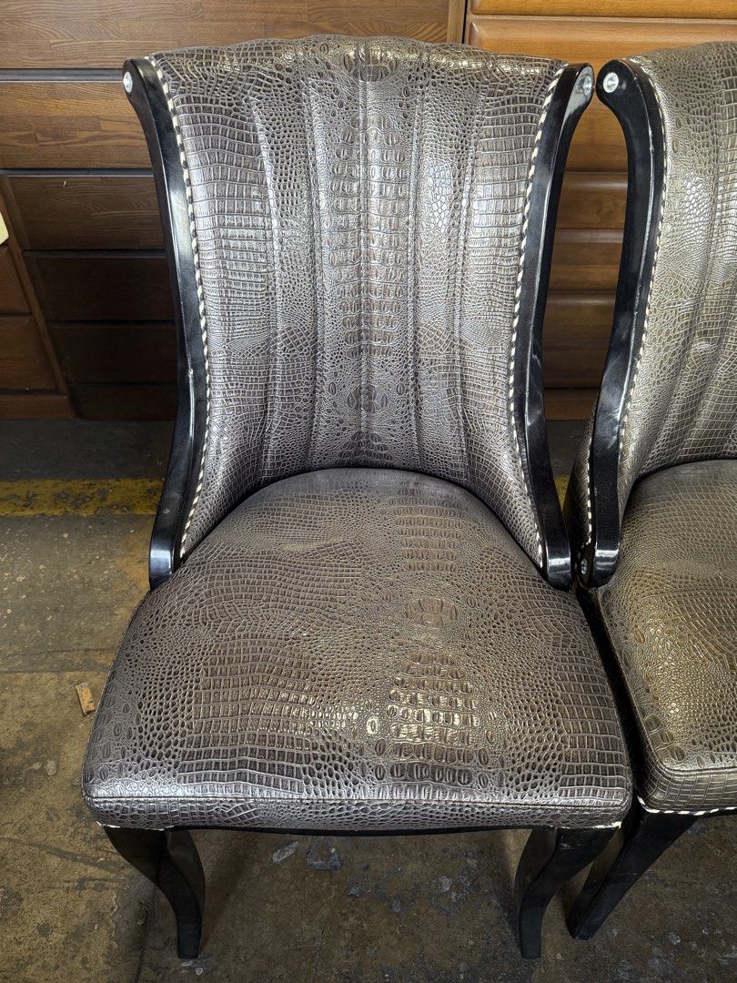 Set of 4 Crocodile Embossed Dining Chairs (Category: Chairs) located in Angeles City. Submitted by maryannmar33098 (Listing ID 1449525174, Image 2). Description: - Set of 4 unique dining chairs - Luxurious crocodile embossed upholstery - Sturdy dark wood frame - Elegant decorative nailhead trim - Comfortable curved backrest design - Versatile: Ideal for dining rooms or as stylish accent chairs ANNA LLANTO JAPAN SURPLUS .