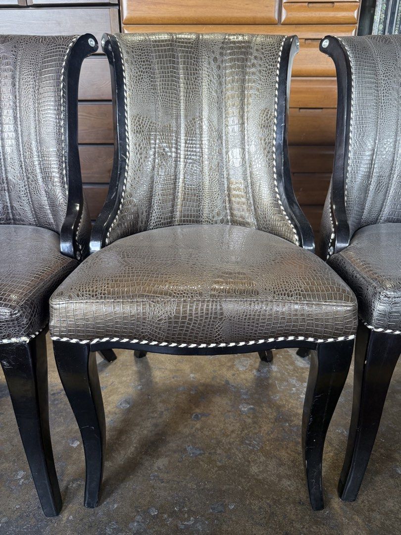 Set of 4 Crocodile Embossed Dining Chairs (Category: Chairs) located in Angeles City. Submitted by maryannmar33098 (Listing ID 1449525174, Image 3). Description: - Set of 4 unique dining chairs - Luxurious crocodile embossed upholstery - Sturdy dark wood frame - Elegant decorative nailhead trim - Comfortable curved backrest design - Versatile: Ideal for dining rooms or as stylish accent chairs ANNA LLANTO JAPAN SURPLUS .
