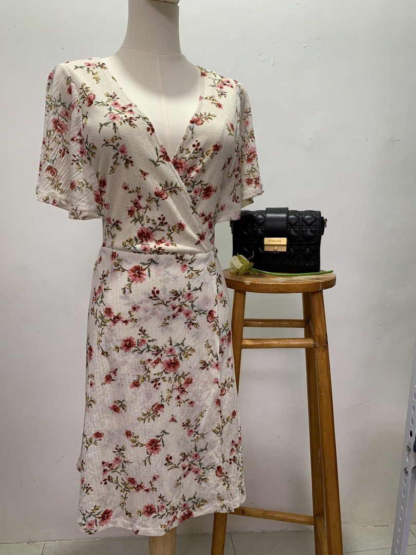 Springfield Floral Wrap Midi Dress (Category: Dresses) located in Las Pinas. Submitted by deargiya (Listing ID 1449509496, Image 2). Description: Medida Sizing: Bust: 36 Waist: 30 Length: 36 - White midi dress with a pretty floral print - Flattering wrap style - Comfortable flutter sleeves - Subtle textured fabric - Perfect for casual outings or dressing up - Ideal for spring and summer wear Loc: Las Piñas City MOP: gcash / bank transfer MOD: Lal