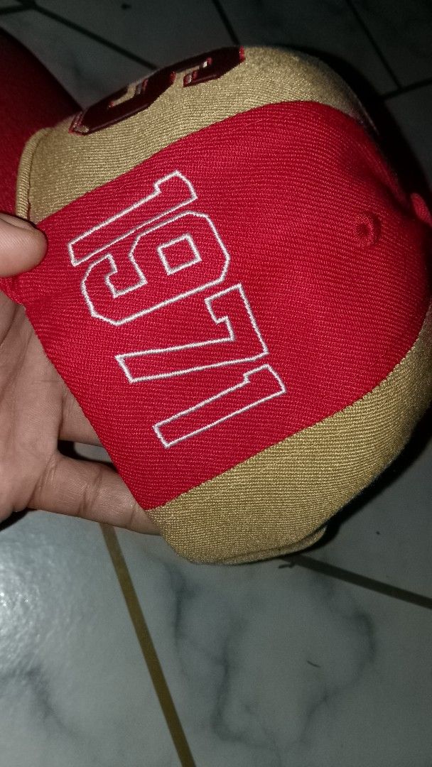 Starter San Francisco 49ers NFL Snapback Cap (Category: Caps & Hats) located in Rizal. Submitted by akosilelouh71119 (Listing ID 1449414275, Image 2). Description: - Starter brand snapback cap - Features San Francisco 49ers logo and helmet graphic - Two-tone red and tan design - '1971' embroidered on the side - NFL football graphic on the back - Adjustable snap closure - Ideal for any 49ers fan.