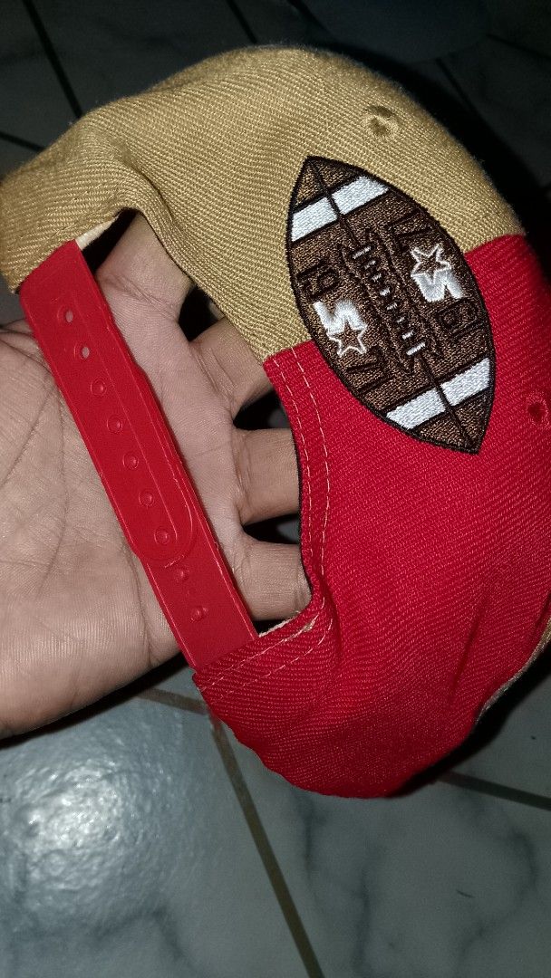 Starter San Francisco 49ers NFL Snapback Cap (Category: Caps & Hats) located in Rizal. Submitted by akosilelouh71119 (Listing ID 1449414275, Image 3). Description: - Starter brand snapback cap - Features San Francisco 49ers logo and helmet graphic - Two-tone red and tan design - '1971' embroidered on the side - NFL football graphic on the back - Adjustable snap closure - Ideal for any 49ers fan.