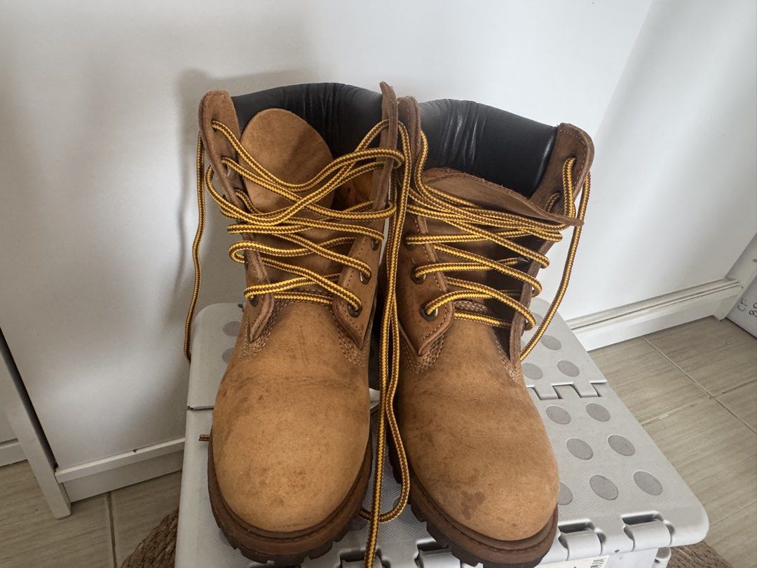 Timberland Style Work Boots Tan Suede Lace Up (Category: Boots) located in Makati City. Submitted by toto_thriftshop2022 (Listing ID 1449344080, Image 2). Description: - Classic tan suede work boots - Black padded collar - Yellow and black laces - Chunky rubber sole for excellent grip - Perfect for outdoor adventures or casual everyday wear - Shows minor scuffs and dirt marks from normal use.