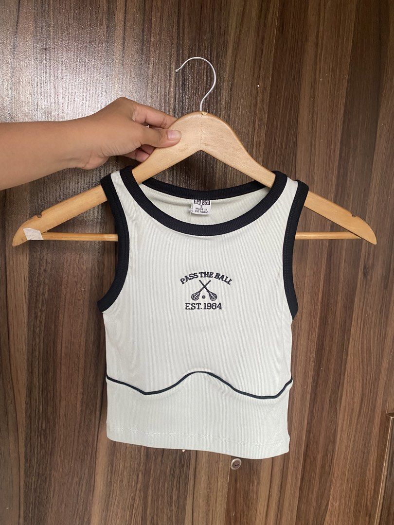 Uniqlo (Tank tops) (Category: Sleeveless) located in Cavite. Submitted by jaydaascollection (Listing ID 1449419231, Image 3). Description: - Cute cropped tank tops from UNIQLO - Ribbed material with contrast trim - Available designs: 'PASS THE BALL EST. 1984', 'LET'S RALLY' - Available colors: white, cream, grey, navy, brown, dusty rose, light green - Comfortable and stylish for casual wear or layering.