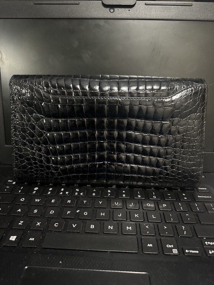 Valentino Black Crocodile Embossed Leather Wallet (Category: Luxury Bags & Wallets) located in Marilao. Submitted by curleylux (Listing ID 1449330128, Image 2). Description: - Genuine black leather wallet - Crocodile embossed finish - Iconic Valentino V logo on front flap - Elegant gold-tone hardware - Ample space for cards and cash - Classic design for everyday elegance.
