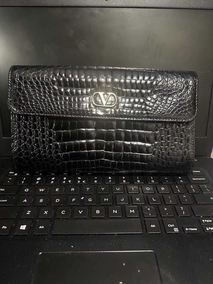 Valentino Black Crocodile Embossed Leather Wallet (Category: Luxury Bags & Wallets) located in Marilao. Submitted by curleylux (Listing ID 1449330128, Image 1). Description: - Genuine black leather wallet - Crocodile embossed finish - Iconic Valentino V logo on front flap - Elegant gold-tone hardware - Ample space for cards and cash - Classic design for everyday elegance.