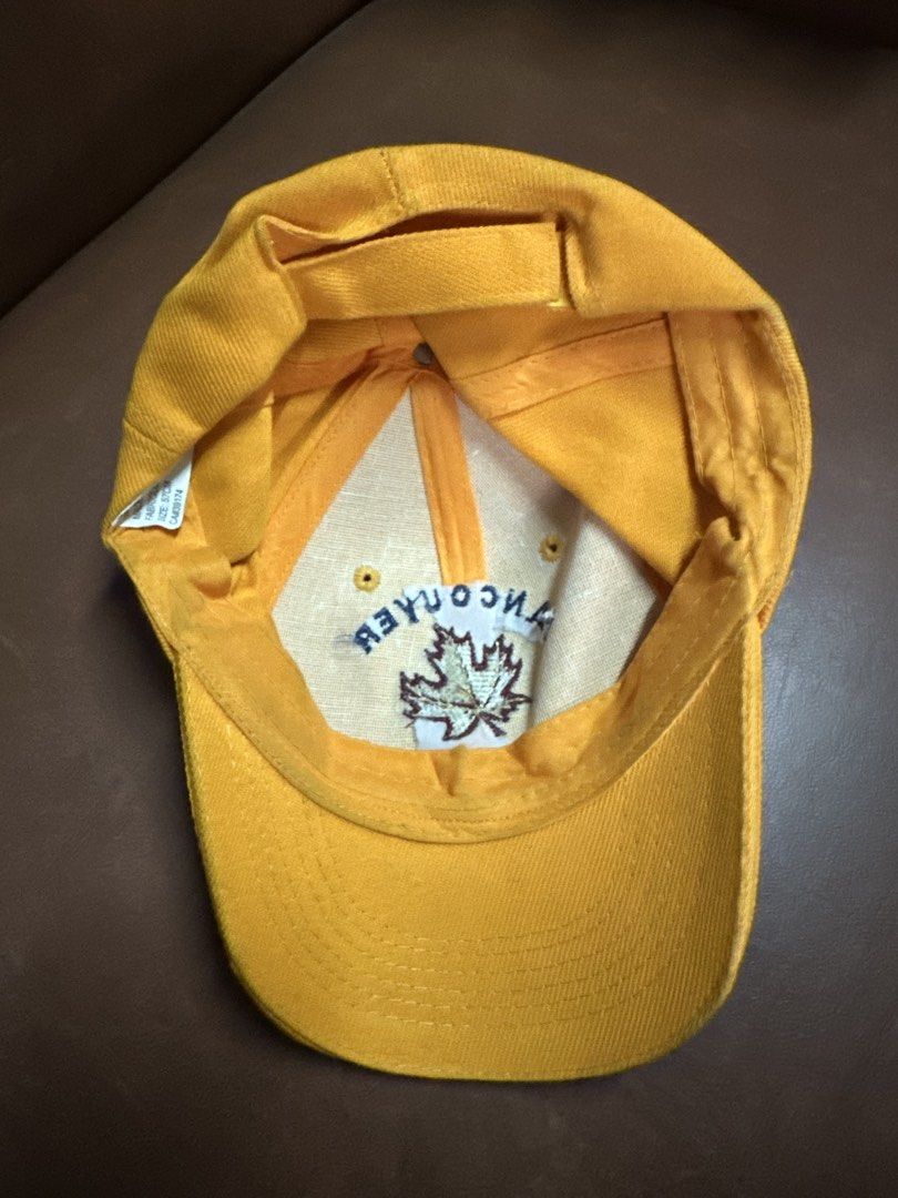 Vancouver Canada Maple Leaf Yellow Baseball Cap (Category: Caps & Hats) located in Manila. Submitted by clamchowder19 (Listing ID 1449416261, Image 2). Description: - Yellow baseball cap from Vancouver, Canada - Features embroidered maple leaf and text - Adjustable strap at the back for a custom fit - Ideal for sunny days or showing Canadian pride - Great for casual wear.