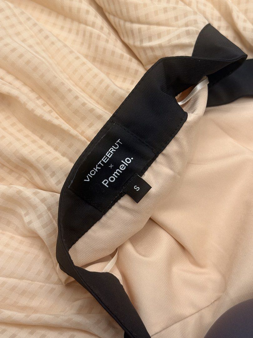 Vickteerut x Pomelo Pleated Halter Top Size S (Category: Sleeveless) located in Taguig. Submitted by kayepeeee (Listing ID 1449458184, Image 3). Description: - Brand: Vickteerut x Pomelo - Style: Pleated Halter Top - Color: Light Peach with Black Trim - Size: S - Details: Pearl embellishments on halter strap - Occasion: Ideal for night outs or special events.