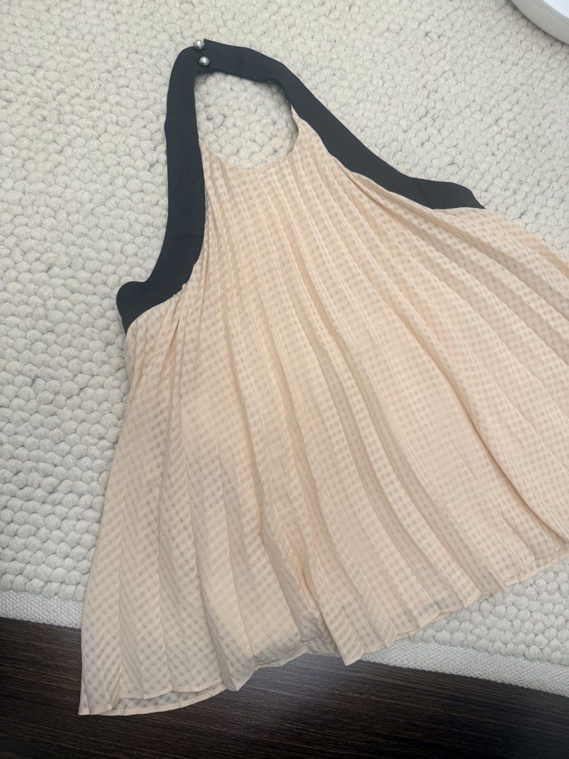 Vickteerut x Pomelo Pleated Halter Top Size S (Category: Sleeveless) located in Taguig. Submitted by kayepeeee (Listing ID 1449458184, Image 2). Description: - Brand: Vickteerut x Pomelo - Style: Pleated Halter Top - Color: Light Peach with Black Trim - Size: S - Details: Pearl embellishments on halter strap - Occasion: Ideal for night outs or special events.