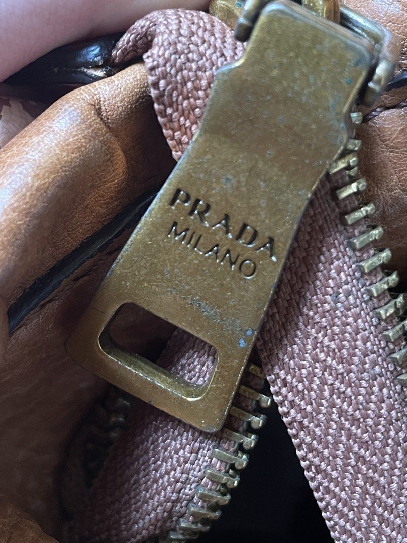 Vintage Prada leather 2 way bag (Category: Luxury Bags & Wallets) located in Makati City. Submitted by coolchic.ave (Listing ID 1449505892, Image 2). Description: OG Vintage Prada Normal Signs of use Hardware: 8/10 no major issue lampo zip Two way w/sling Year 2000’s bag Can meet up if around bgc.