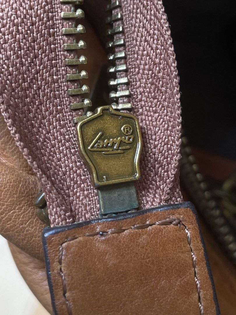 Vintage Prada leather 2 way bag (Category: Luxury Bags & Wallets) located in Makati City. Submitted by coolchic.ave (Listing ID 1449505892, Image 3). Description: OG Vintage Prada Normal Signs of use Hardware: 8/10 no major issue lampo zip Two way w/sling Year 2000’s bag Can meet up if around bgc.