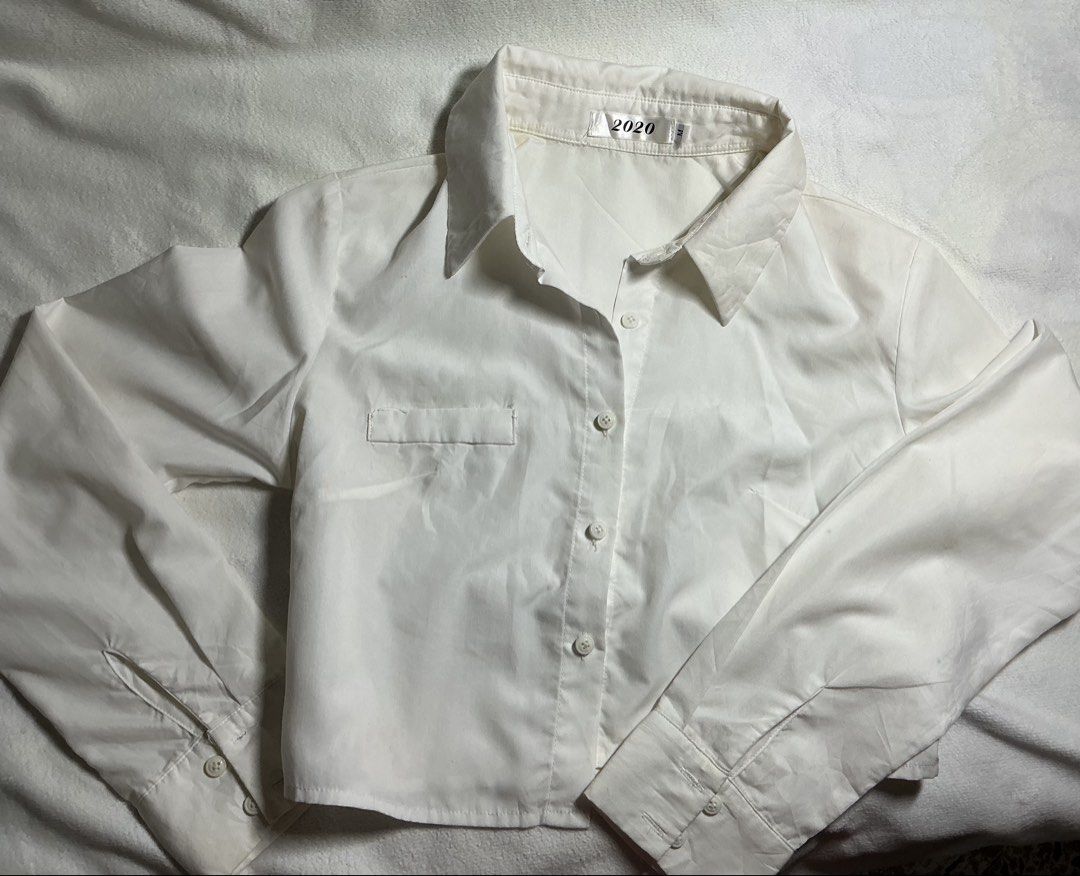 White Cropped Long Sleeve Button Up Shirt (Category: Longsleeves) located in Makati City. Submitted by studentista (Listing ID 1449511427, Image 1). Description: - White cropped shirt - Long sleeves - Button-up front - Single chest pocket (left side) - Estimated Size: S - Versatile: Great for layering or wearing on its own.