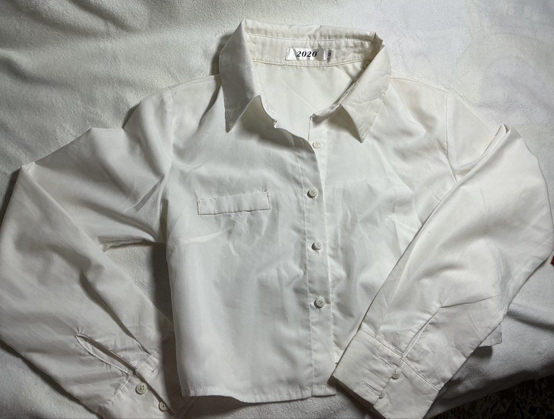 White Cropped Long Sleeve Button Up Shirt (Category: Longsleeves) located in Makati City. Submitted by studentista (Listing ID 1449511427, Image 2). Description: - White cropped shirt - Long sleeves - Button-up front - Single chest pocket (left side) - Estimated Size: S - Versatile: Great for layering or wearing on its own.
