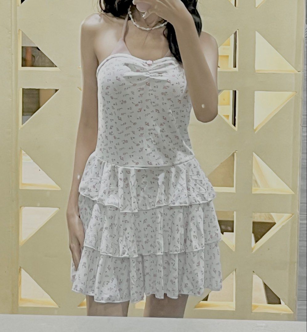 White Floral Tiered Strapless Mini Dress (Category: Dresses) located in Calauan. Submitted by emyelgi (Listing ID 1449334836, Image 1). Description: - White strapless mini dress - Pink floral print - Ribbed bodice - Tiered, ruffled skirt - Ruffled hemline - Estimated size: Small to Medium - Ideal for summer days or casual parties.