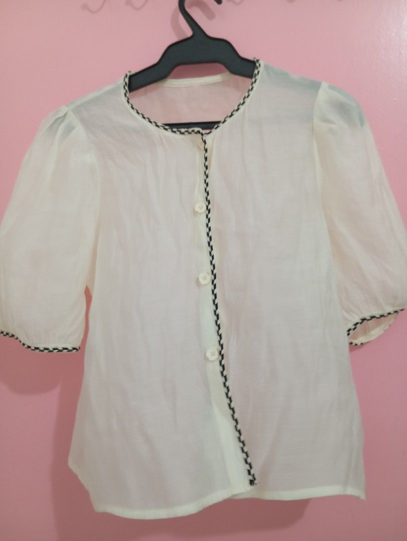 White Puff Sleeve Blouse with Black Trim (Category: Blouses) located in Manila. Submitted by brion123 (Listing ID 1449494663, Image 1). Description: - Cute white sheer blouse - Short puff sleeves - Round neckline with black zigzag trim - Three buttons down the front - Versatile for layering or wearing on its own - Perfect for casual or dressy looks.
