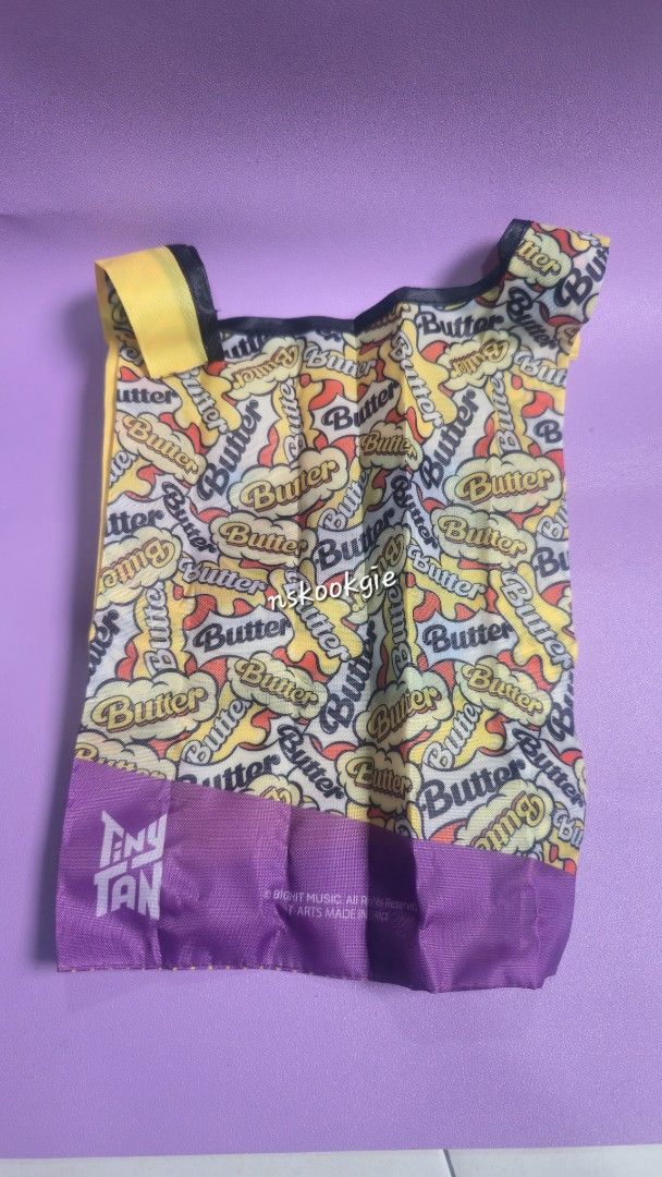 (WTS) BTS Official Japan TinyTAN Butter Suga eco-bag - SUGA (Category: K-Wave) located in Petaling Jaya. Submitted by nskookgie (Listing ID 1449400769, Image 2). Description: • Takara Tomy Arts • Bought from Japan. •The bag features a "fist" and purple polka dot design themed around the BTS "Butter" music video. •The approximate dimensions are 225mm in width and 395mm in height. • NEVER USE! 📍MY only. • Price exclude postage. • FREEBIES will be 