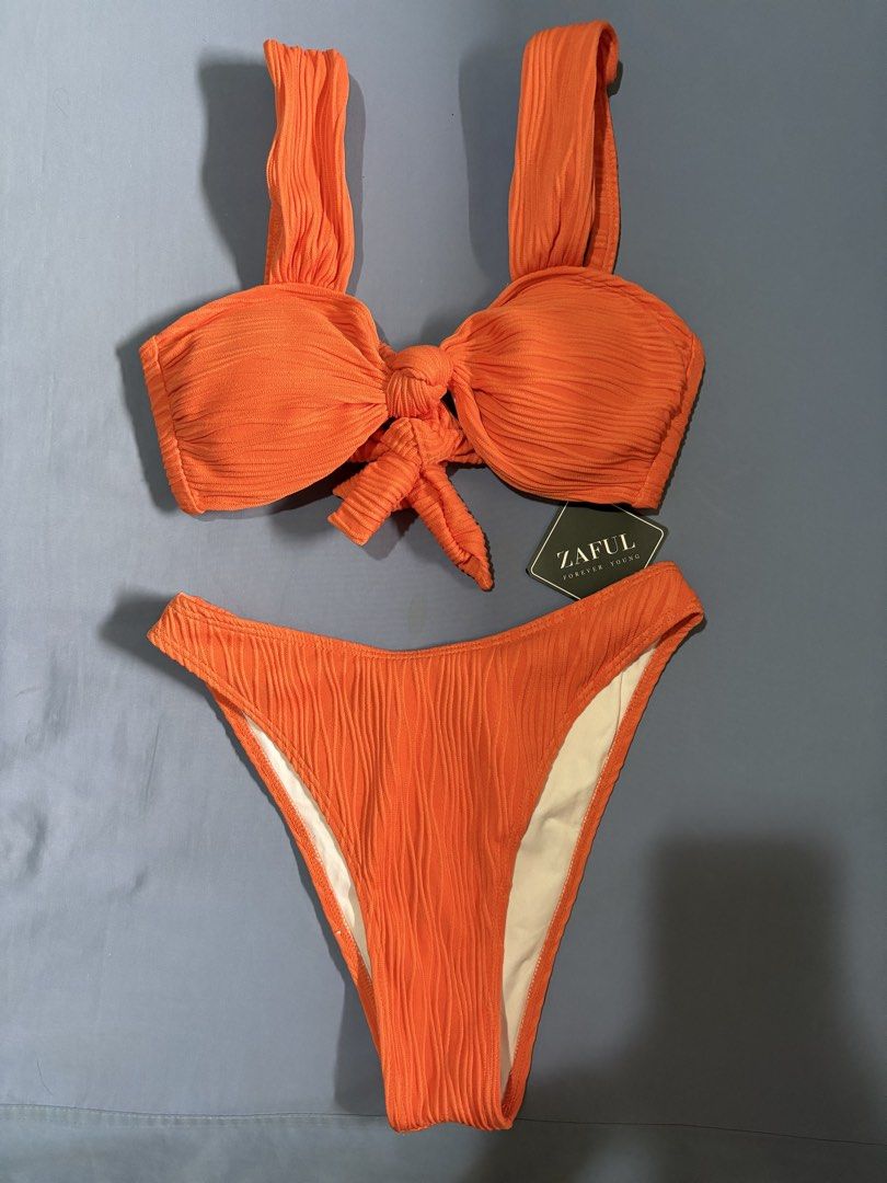 Zaful Orange Textured Tie-Front Bikini Set (Category: Bikinis & Swimsuits) located in Quezon City. Submitted by ela___ (Listing ID 1449348946, Image 1). Description: - Zaful orange textured bikini set - Features a tie-front top with adjustable straps - High-waisted bottoms - Perfect for beach trips or pool days - Comfortable and stylish.