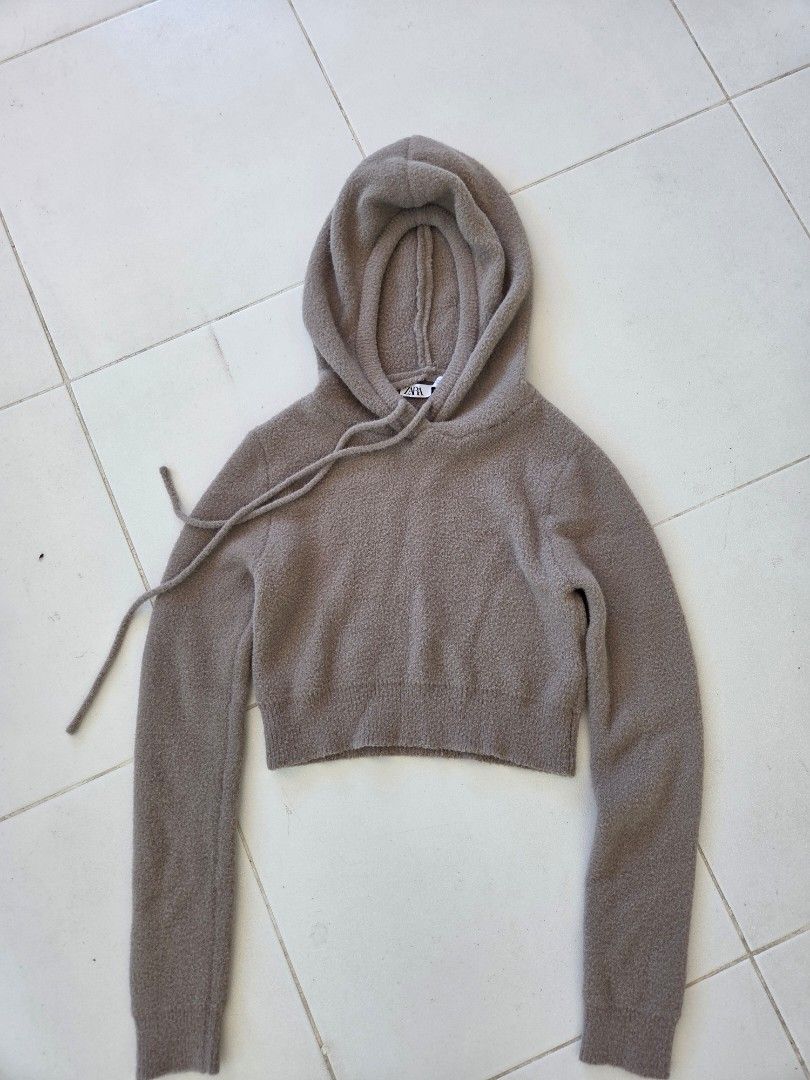 ZARA Cropped Knit Hoodie (Category: Coats, Jackets and Outerwear) located in Quezon City. Submitted by sdp_enterprise (Listing ID 1449340373, Image 2). Description: - Super soft cropped hoodie from ZARA - Color: Taupe/Brownish - Features drawstrings on the hood - Measurements: Width 14 inches (laid flat), Length 14 inches - Versatile: Great for layering or wearing on its own.