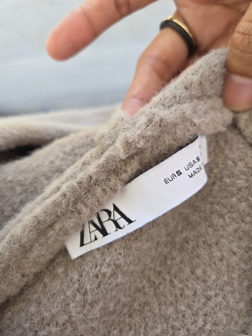 ZARA Cropped Knit Hoodie (Category: Coats, Jackets and Outerwear) located in Quezon City. Submitted by sdp_enterprise (Listing ID 1449340373, Image 3). Description: - Super soft cropped hoodie from ZARA - Color: Taupe/Brownish - Features drawstrings on the hood - Measurements: Width 14 inches (laid flat), Length 14 inches - Versatile: Great for layering or wearing on its own.