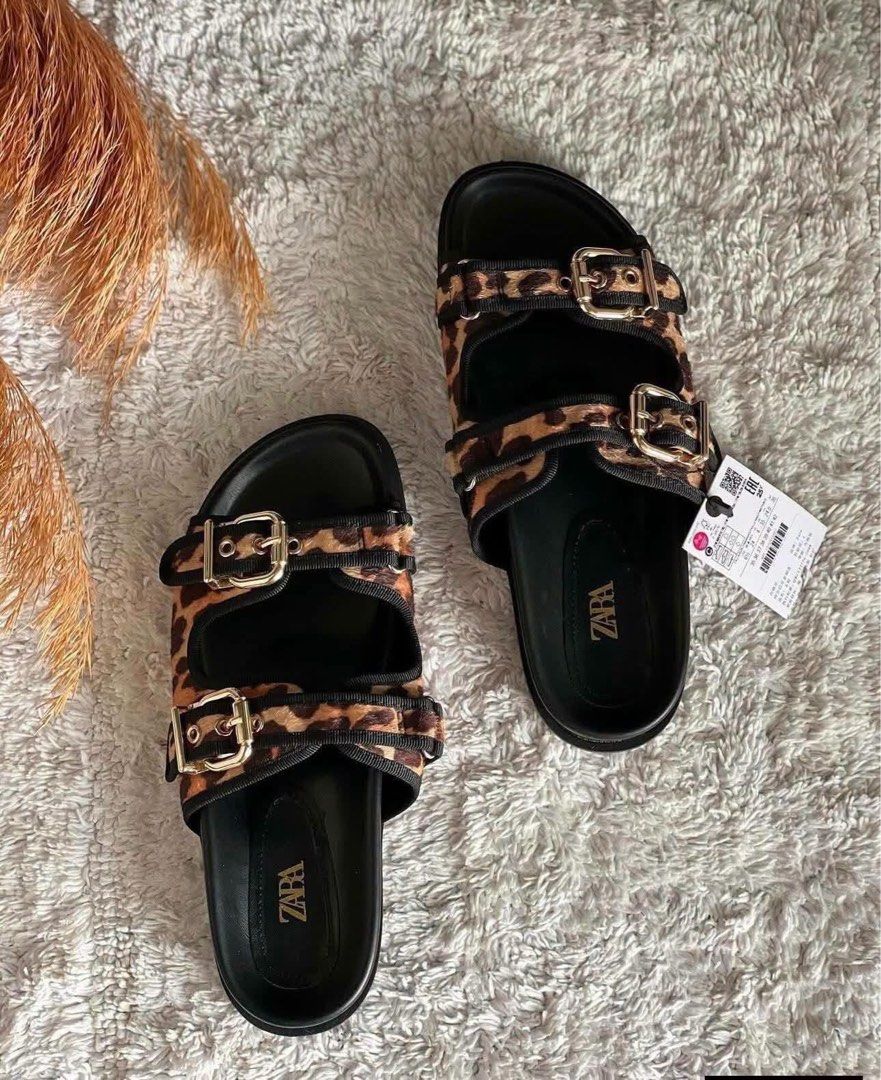 ZARA Leopard Print Double Strap Buckle Slides Sandals (Category: Flats & Sandals) located in Las Pinas. Submitted by ladyattire (Listing ID 1449479461, Image 1). Description: - Cute ZARA leopard print slides - Double strap design with adjustable buckles - Black sole with ZARA logo - Perfect for casual outings - Available sizes: 35 (US 4), 36 (US 6), 39 (US 1) - Includes original box and paper bag - Comfy and stylish flats.