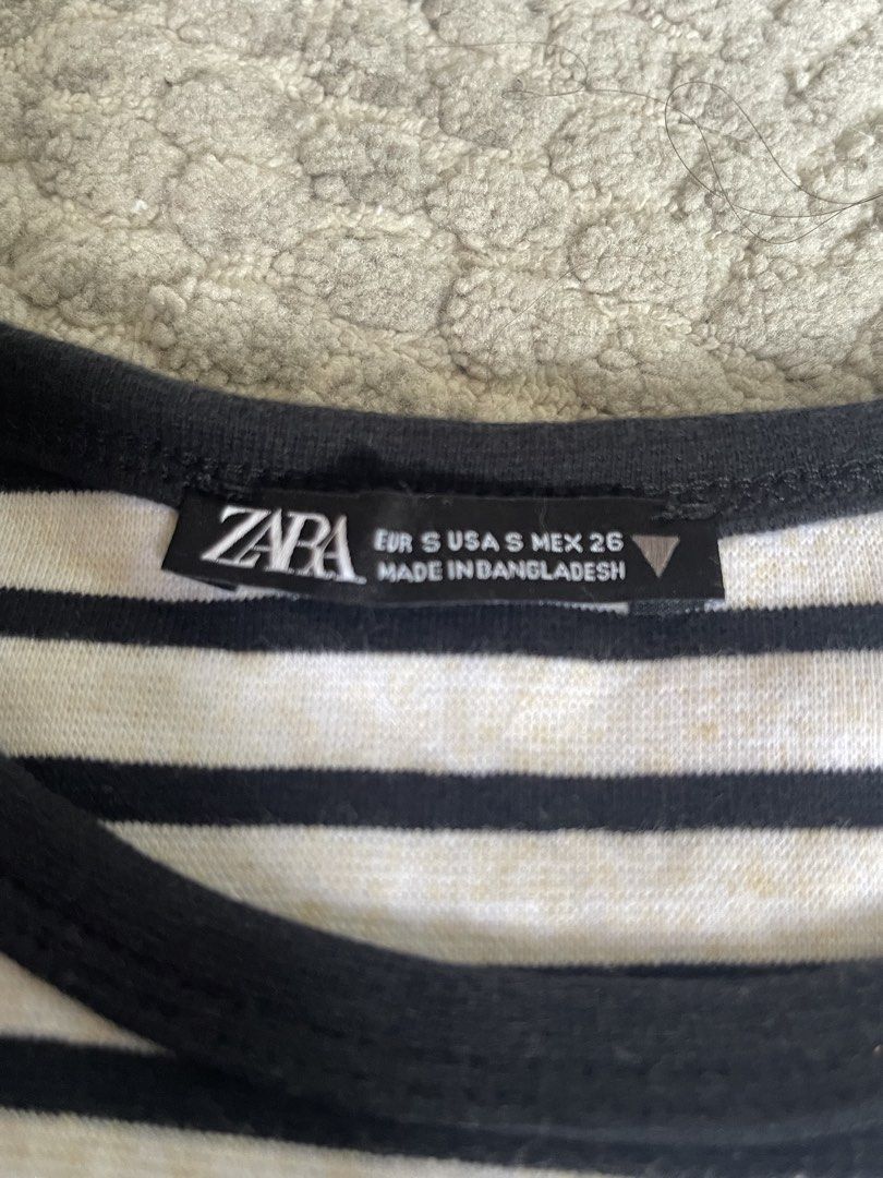 Zara Striped Cropped Baby-Tee Size S (Category: Shirts) located in Manila. Submitted by shoptjg (Listing ID 1449394888, Image 2). Description: - Classic black and white striped cropped t-shirt - Brand: Zara - Style: Short sleeves, crew neck - Material: Comfortable cotton blend - Origin: Made in Bangladesh - Versatile: Easy to pair with jeans or shorts for a casual look.