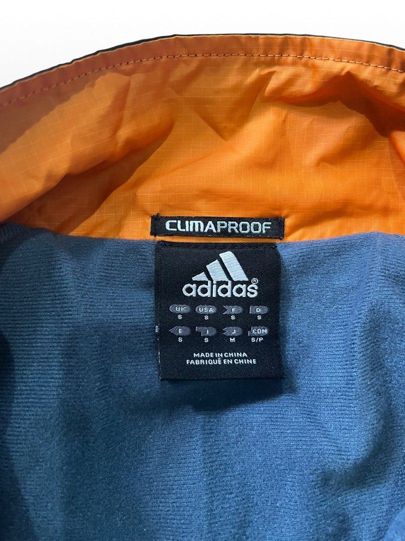 ADIDAS CLIMAPROOF WINDBREAKER JACKET (Category: Coats, Jackets and Outerwear) located in Valencia. Submitted by hunterxthrifter (Listing ID 1449658756, Image 2). Description: GOOD AS NEW Y2K STYLE SIZE LARGE LIGHT WEIGHT NAVY BLUE COLOR WAY AND ORANGE W-23.5 L-28.5.