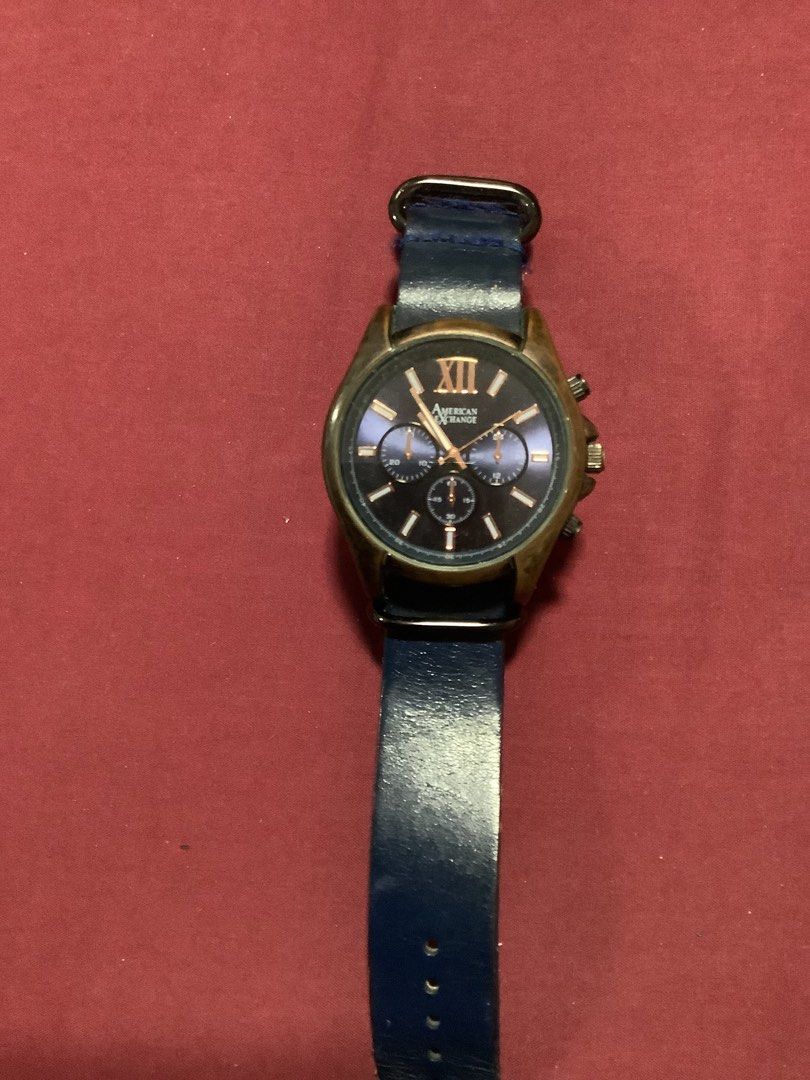 American Exchange Chronograph Watch Blue Leather Strap (Category: Luxury Watches) located in Valenzuela. Submitted by trinidad.edna (Listing ID 1449554996, Image 2). Description: - American Exchange watch - Blue leather strap with some signs of wear - Dark blue dial with Roman numerals - Chronograph function - Selling as is.