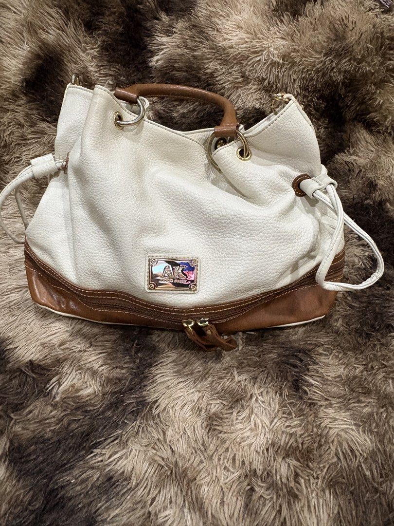 Anne Klein White & Brown Leather Shoulder Bag (Category: Shoulder Bags) located in Cebu City. Submitted by cmkaiser07 (Listing ID 1449685034, Image 1). Description: - White pebbled leather with brown leather trim - Top handles and detachable shoulder strap - Gold hardware details - Interior: 1 zippered pocket, 2 slip pockets - Clean interior - Ideal everyday bag 📌 PLEASE READ ✅ Payment first policy 🚚 Buyer shoulders SF 📍 Metro Cebu: Maxim/Lala