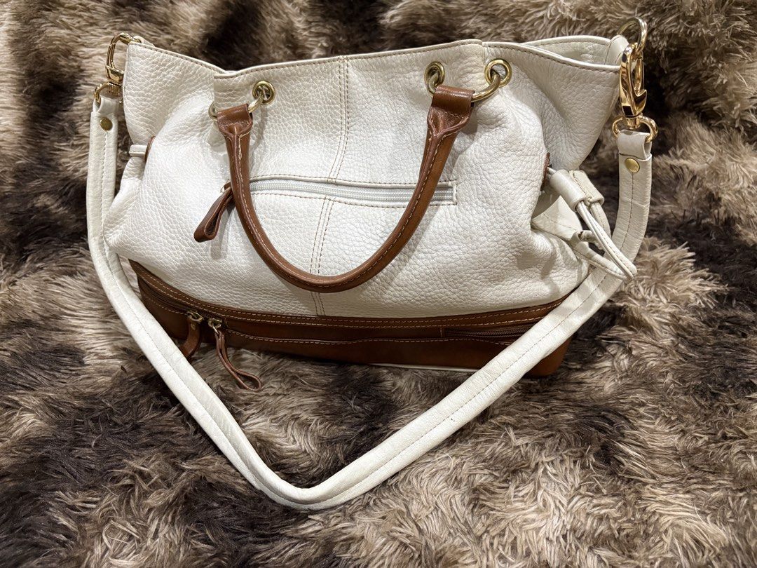 Anne Klein White & Brown Leather Shoulder Bag (Category: Shoulder Bags) located in Cebu City. Submitted by cmkaiser07 (Listing ID 1449685034, Image 2). Description: - White pebbled leather with brown leather trim - Top handles and detachable shoulder strap - Gold hardware details - Interior: 1 zippered pocket, 2 slip pockets - Clean interior - Ideal everyday bag 📌 PLEASE READ ✅ Payment first policy 🚚 Buyer shoulders SF 📍 Metro Cebu: Maxim/Lala