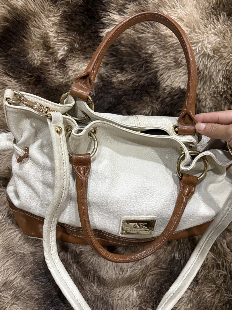 Anne Klein White & Brown Leather Shoulder Bag (Category: Shoulder Bags) located in Cebu City. Submitted by cmkaiser07 (Listing ID 1449685034, Image 3). Description: - White pebbled leather with brown leather trim - Top handles and detachable shoulder strap - Gold hardware details - Interior: 1 zippered pocket, 2 slip pockets - Clean interior - Ideal everyday bag 📌 PLEASE READ ✅ Payment first policy 🚚 Buyer shoulders SF 📍 Metro Cebu: Maxim/Lala