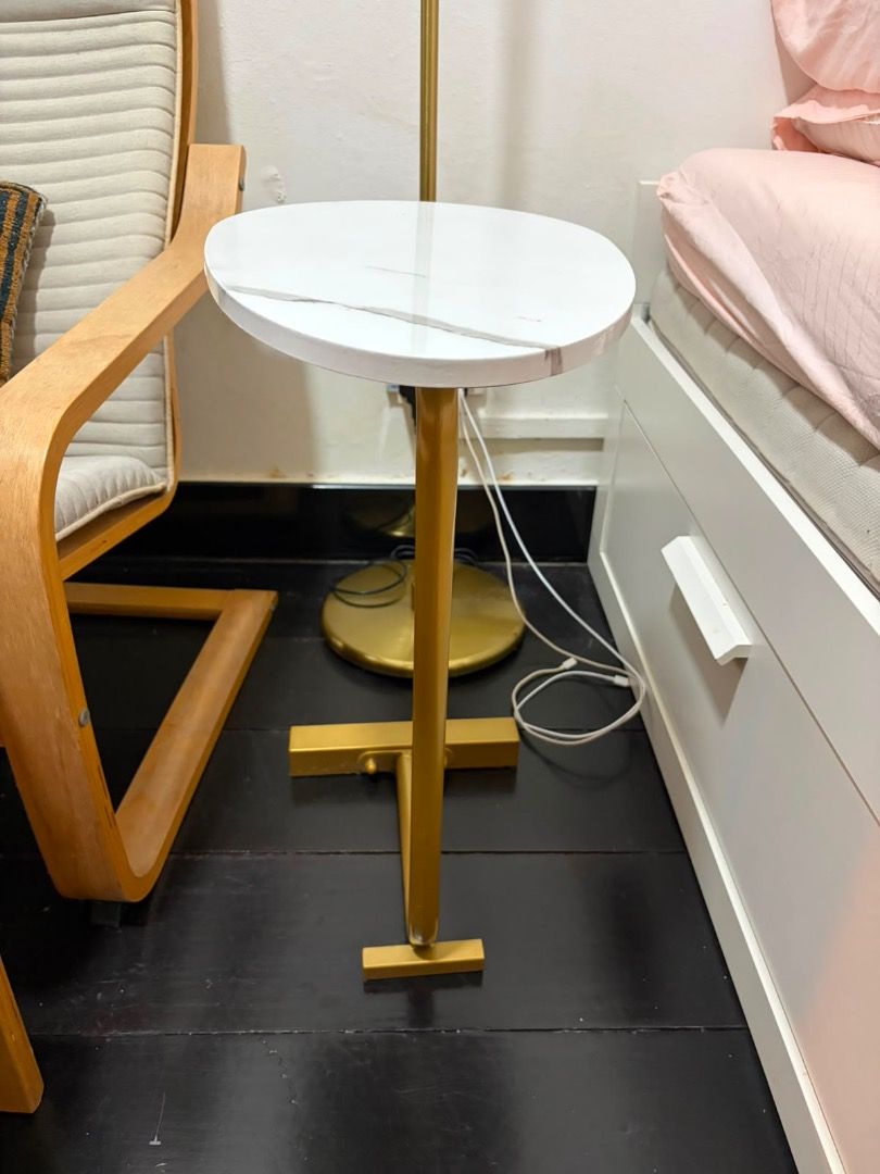 FREE Bedside table (Category: Tables & Sets) located in Singapore. Submitted by akinks (Listing ID 1449581994, Image 2). Description: A great space saver side table with adhesive bottom. A bit of a wobbly leg but just needs screws tightened. Slight stain as pictured (picture 3) Stylish bedside table with a white marble-effect top - Elegant gold metal base with a unique, space-saving design - Oval tabletop provides ample space for essentials - Add