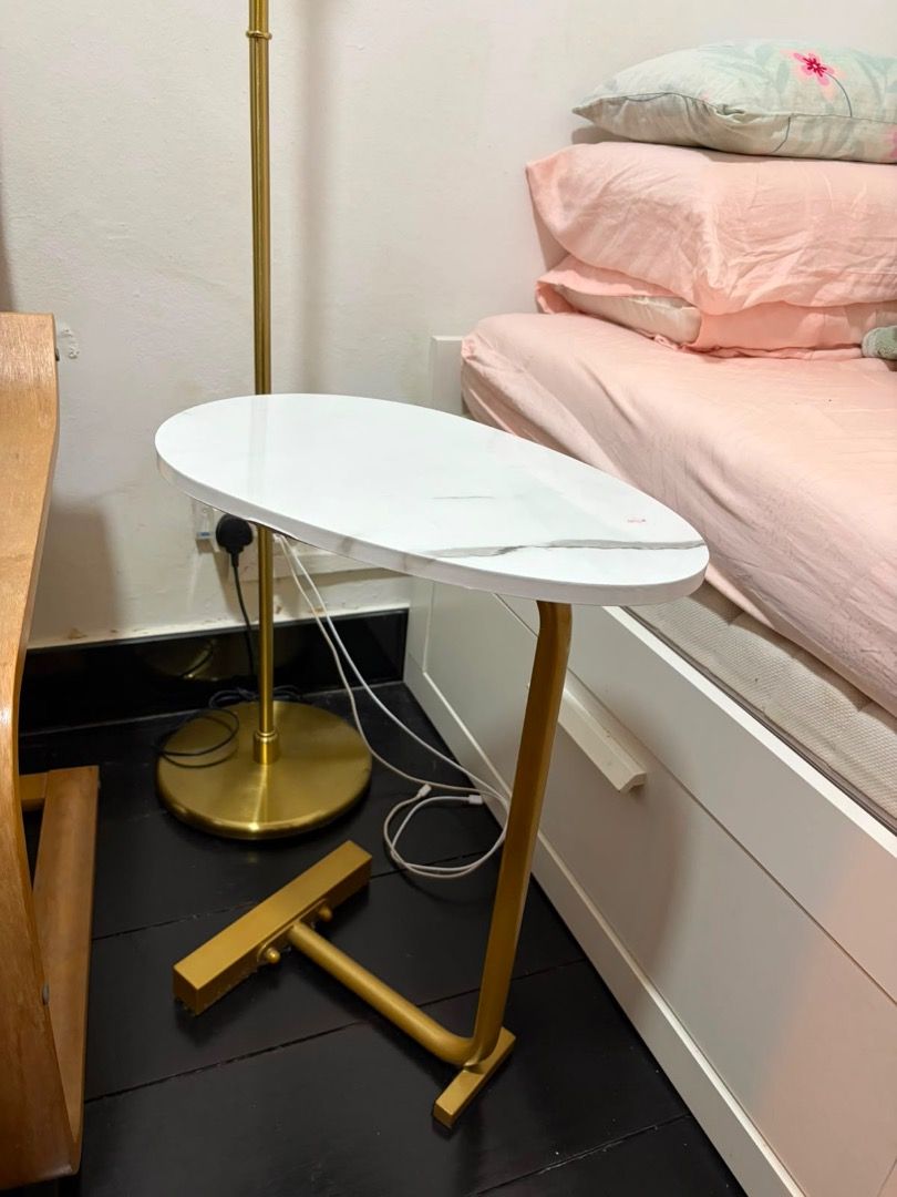 FREE Bedside table (Category: Tables & Sets) located in Singapore. Submitted by akinks (Listing ID 1449581994, Image 1). Description: A great space saver side table with adhesive bottom. A bit of a wobbly leg but just needs screws tightened. Slight stain as pictured (picture 3) Stylish bedside table with a white marble-effect top - Elegant gold metal base with a unique, space-saving design - Oval tabletop provides ample space for essentials - Add