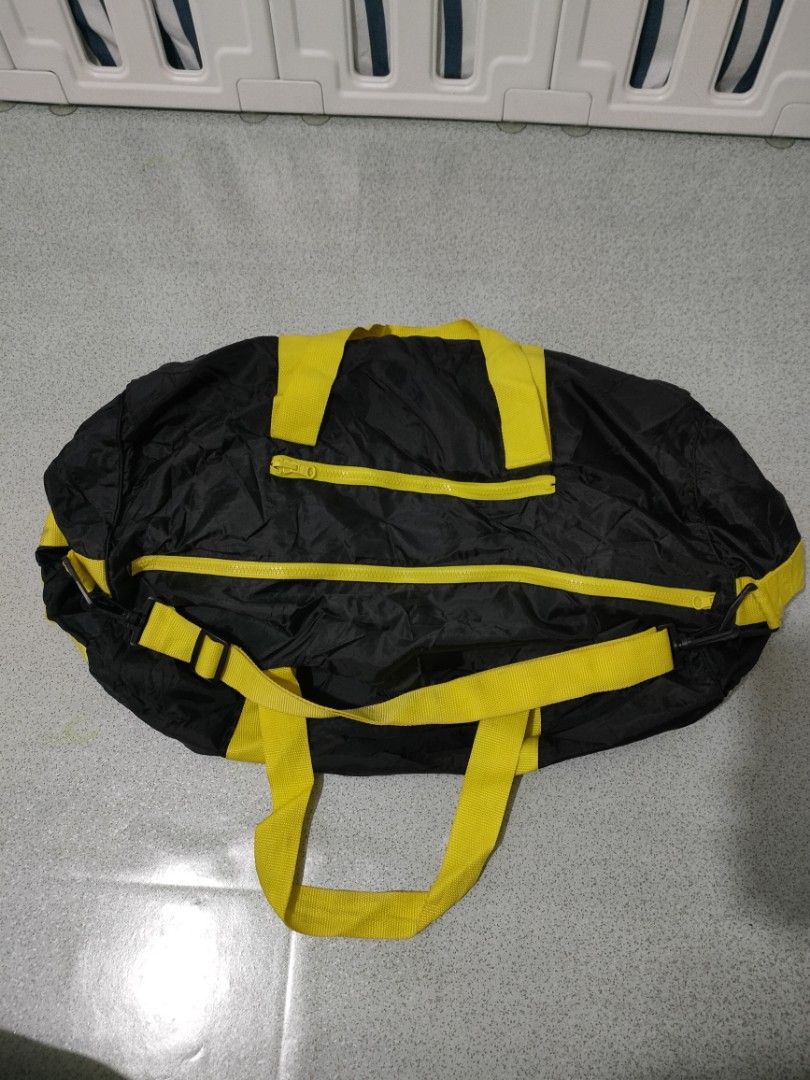 Black and Yellow Duffel Bag (Category: Shoulder Bags) located in General Santos City (Dadiangas). Submitted by rjb21 (Listing ID 1449698699, Image 1). Description: - Stylish black travel bag with vibrant yellow accents. - Convenient dual handles for easy carrying. - Secure zipper closure to keep your belongings safe. - Extra front zipper pocket for quick access to essentials. - Ideal for gym sessions or short getaways. - Folds up small for conven