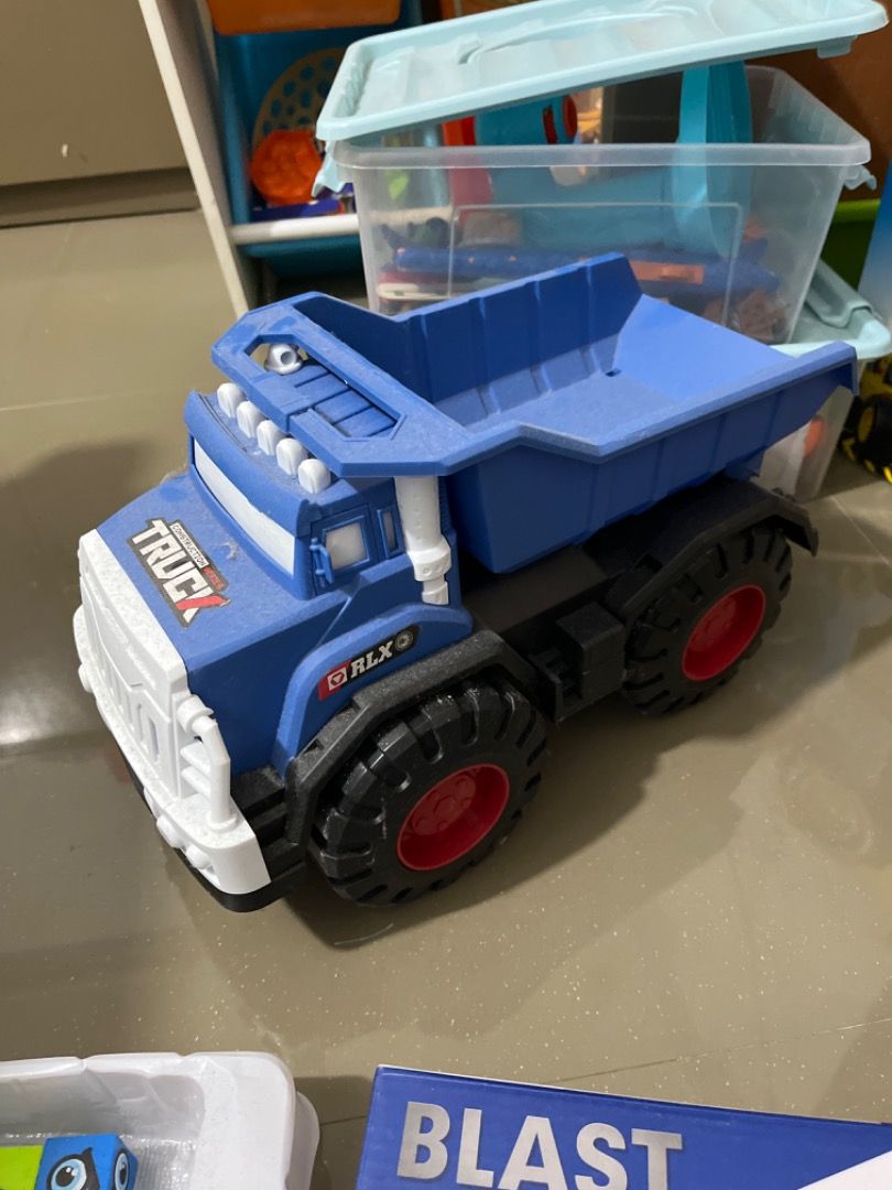 Blue RLX Dump Truck Toy (Category: Kids Toys) located in Santiago. Submitted by evrythngulove (Listing ID 1449601662, Image 1). Description: Big blue RLX dump truck toy with a lifting dump bed and chunky tires with red rims. Perfect for kids' imaginative play!.