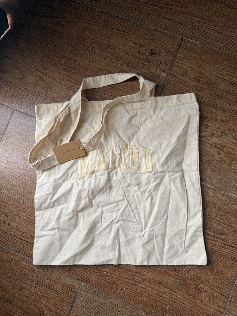Brandy Melville Tote Bag (Category: Tote Bags) located in Quezon City. Submitted by jong_17 (Listing ID 1449664195, Image 1). Description: - Cream colored tote bag - 'MALIBU' embroidered in yellow - brand new with tag.