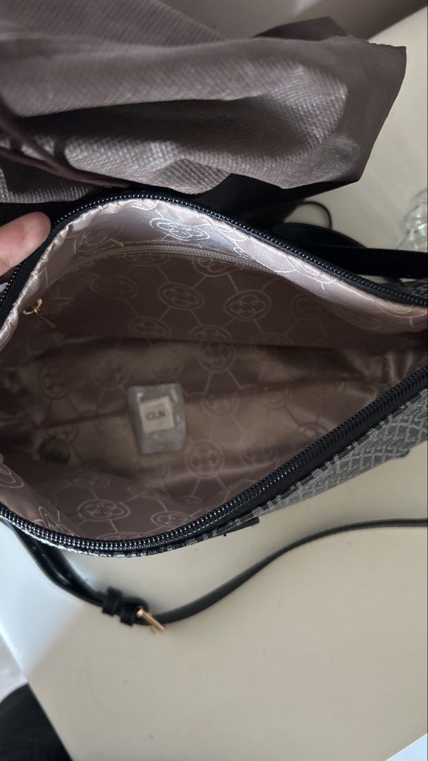 CLN Monogram Crossbody Bag with Dust Bag (Category: Cross-body Bags) located in Makati City. Submitted by carrillopr37736 (Listing ID 1449621906, Image 3). Description: - CLN Monogram Crossbody Bag - Classic black and white all-over pattern - Adjustable strap with buckle detail - Interior features a patterned lining - Comes with original dust bag - Ideal for everyday wear.