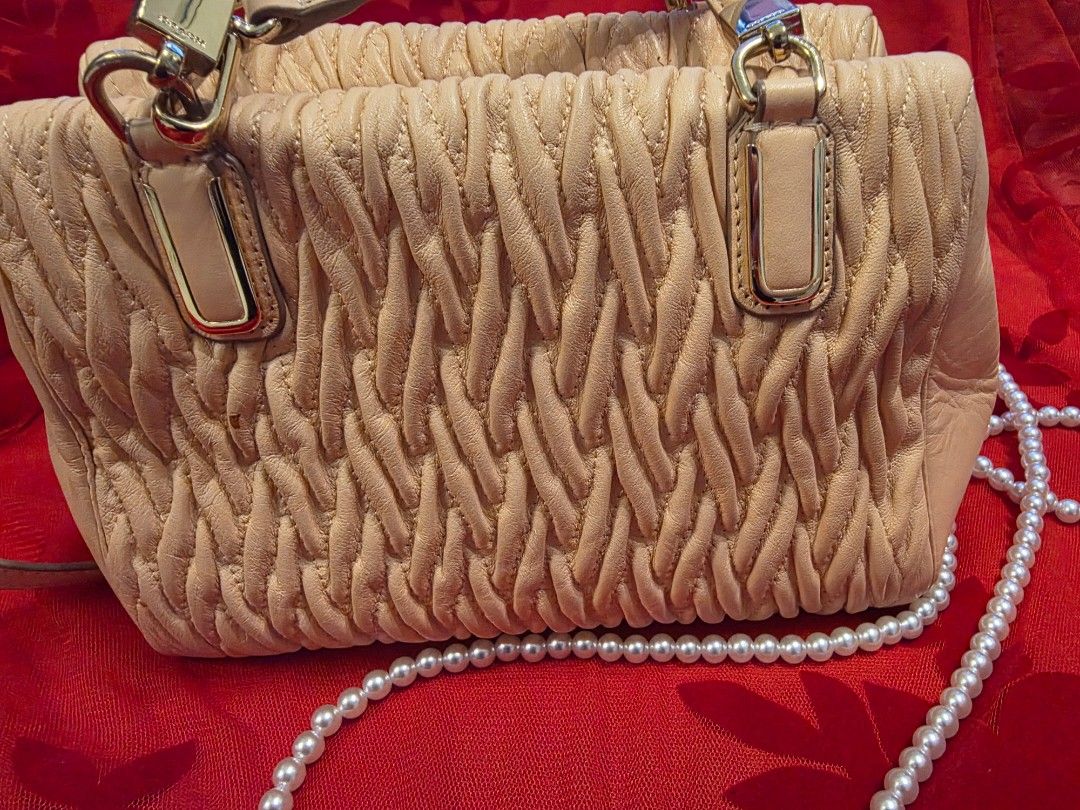 Coach Beige Quilted Leather Shoulder Bag (Category: Luxury Bags & Wallets) located in Dasmarinas. Submitted by carousel111222 (Listing ID 1449648837, Image 3). Description: -UNUSED / PRISTINE Coach Madison -Gathered Twist Leather Mini Satchel - Beige quilted leather Coach handbag with a unique woven texture. - Comes with a detachable - Versatile for everyday use or special occasions. - Clean interior. - Gold-toned hardware. - with almost unnotice