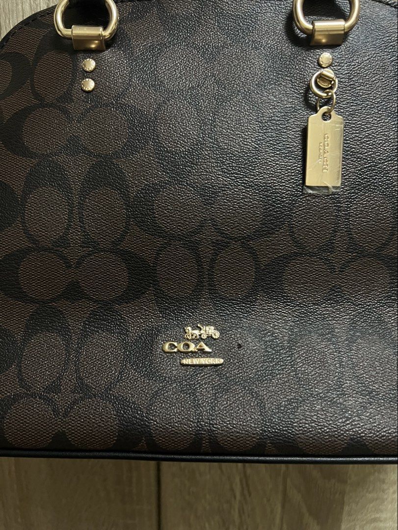 Coach Signature Canvas Monogram Dome Katy Satchel Bag (Category: Luxury Bags & Wallets) located in Cebu City. Submitted by seokjin. (Listing ID 1449638024, Image 3). Description: Coach Katy Satchel Bag - Top handles and detachable shoulder strap - Includes (stained) dust bag and care card - The bag is in really good condition as in hindi pa talaga nagamit this was only stored, the only issue is that some letters of the logo snapped off 🥹 and idk