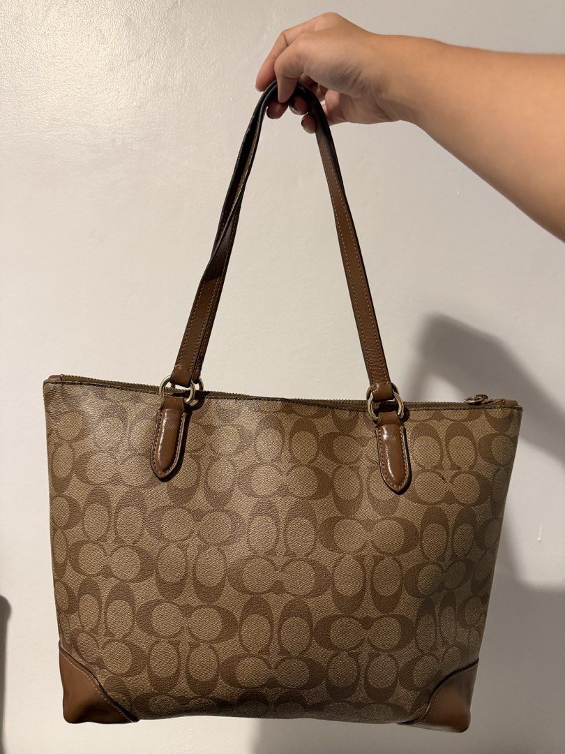 Well loved Tote Bag Coach in brown (Category: Tote Bags) located in Tanza. Submitted by shop.yvone (Listing ID 1449595234, Image 2). Description: Well loved Tote Bag Coach in brown Coach Zip Top Tote in Signature Canvas Style Number: F29208 (found on the second part of the serial number: G1822-F29208) Material: Signature Canvas / Crossgrain Leather Dimensions: Approximately 10.5” (L) x 9.5” (H) x 4.5” (W) - Well-loved bag - visible vintage patina