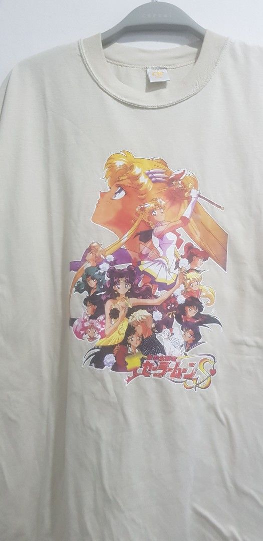 Sailor moon Cream T-shirt new old stock (Category: Other Tops) located in Petaling Jaya. Submitted by jesbirkaur71 (Listing ID 1449679363, Image 1). Description: - Cream colored t-shirt 1994 sailor moon movie print -details on this is in last 2 pictures - Features a large, colorful graphic print of anime characters on the front - Ideal for anime enthusiasts - not used but kept long and have bit stain from kept long - Suitable for casual everyday 