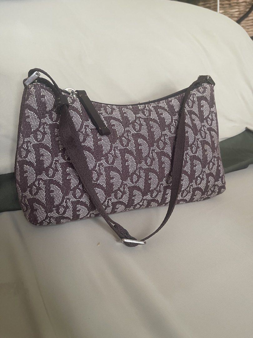 Dior Monogram Canvas Shoulder Bag (Category: Luxury Bags & Wallets) located in Quezon City. Submitted by shoppeberna (Listing ID 1449581656, Image 2). Description: - Authentic Christian Dior shoulder bag - Classic brown and white monogram pattern - Secure zipper closure - Made in Italy - Compact, small size - perfect for essentials - Adjustable shoulder strap - Shows some signs of wear on the strap and fabric.