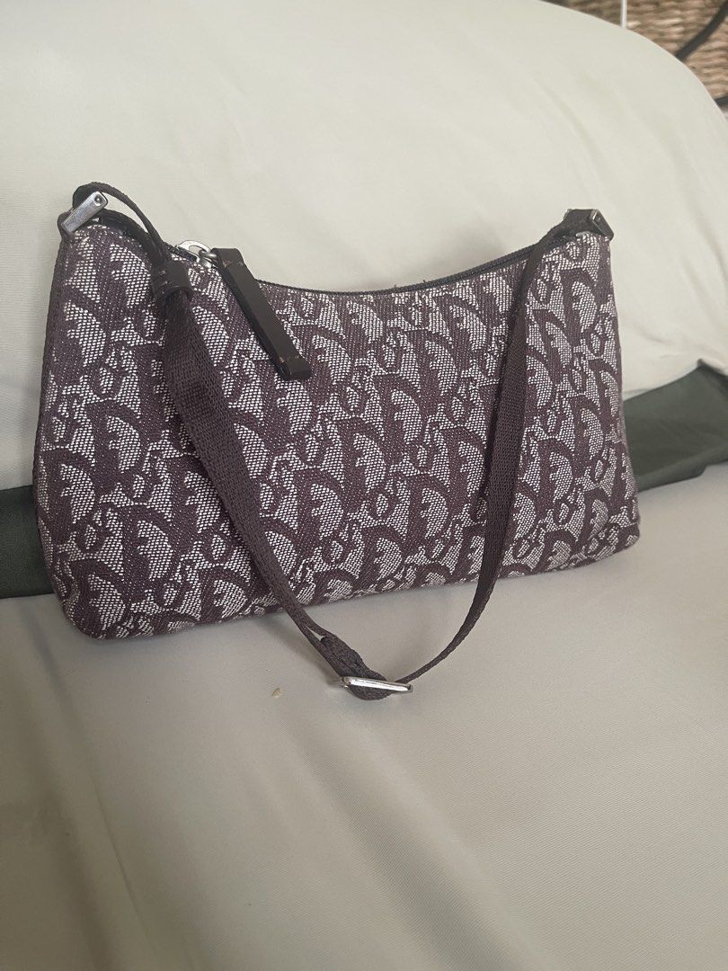 Dior Monogram Canvas Shoulder Bag (Category: Luxury Bags & Wallets) located in Quezon City. Submitted by shoppeberna (Listing ID 1449581656, Image 1). Description: - Authentic Christian Dior shoulder bag - Classic brown and white monogram pattern - Secure zipper closure - Made in Italy - Compact, small size - perfect for essentials - Adjustable shoulder strap - Shows some signs of wear on the strap and fabric.