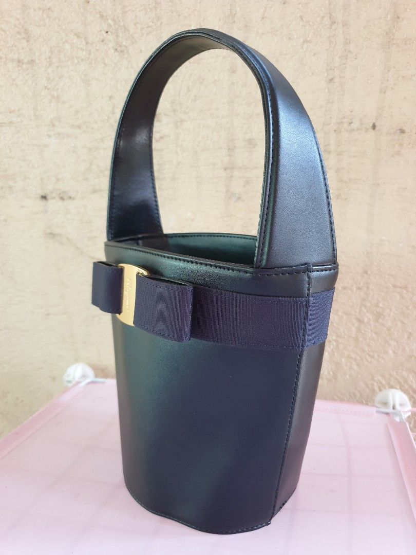 Ferragamo Leather Bucket Bag (Category: Luxury Bags & Wallets) located in Las Pinas. Submitted by anggesmart (Listing ID 1449547529, Image 2). Description: Preloved Salvatorre Ferragamo Vara Bucket Bag. Comes in black leather with iconic Vara bow in gold hardware & navy blue trimming. Single top handle with interior zippered compartment. Compliments any outfit, stylish & classy! pls manage expectations, with signs of usage.