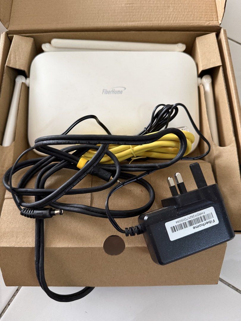 FiberHome WiFi Router with Power Adapter and Cables (Category: Networking) located in Kuala Lumpur. Submitted by ameera. (Listing ID 1449564636, Image 1). Description: - FiberHome WiFi Router - Excellent working condition - Original power adapter included - Network cables included - Ready for immediate home network setup.