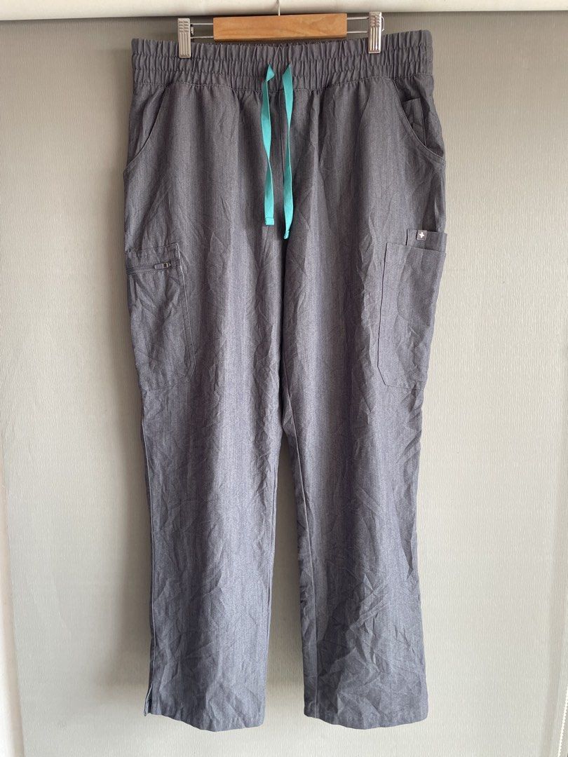 FIGS Technical Collection Scrub Pants L/P Grey (Category: Other Bottoms) located in Mataasnakahoy. Submitted by zero4thrift (Listing ID 1449589132, Image 1). Description: These are FIGS Yola skinny scrub pants in a gray shade with an aqua drawstring. - Size: L/P - Collection: Technical - Material: Polyester, Rayon, Spandex blend - Features: Comfortable elastic waistband with drawstring, multiple pockets including a zippered pocket - Ideal for: He
