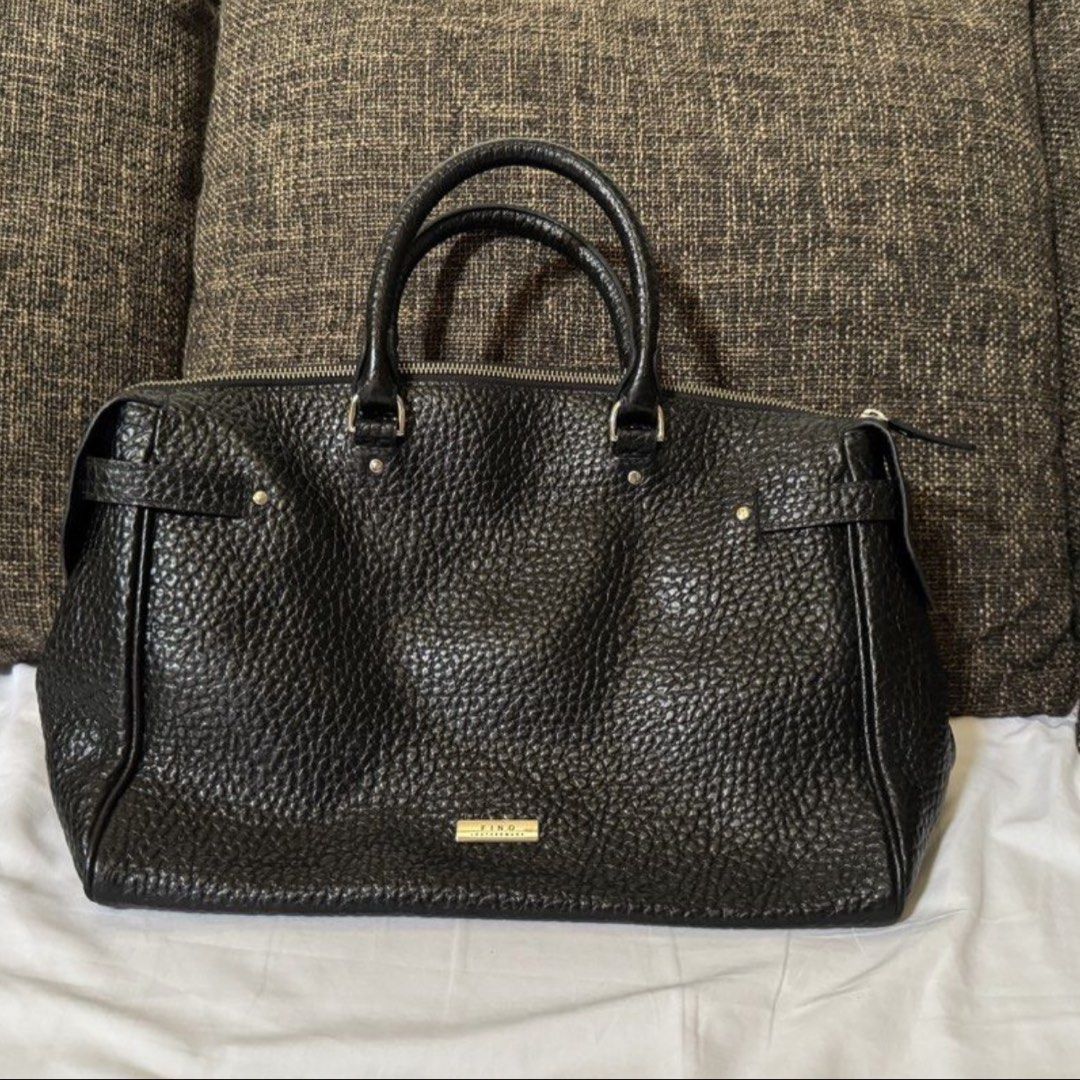 FINO Black Leather Bag (Category: Tote Bags) located in Rizal. Submitted by matchapeppernacho (Listing ID 1449713057, Image 1). Description: Fino Leatherware black handbag - Textured leather exterior - Double top handles - Secure zip closure - Elegant silver-tone logo plaque - Structured, rectangular silhovette - Stylish metal accents bought at fino store robinsons magnolia, used thrice and stored. RFS: too many bags, MAJOR DECLUTTERING .