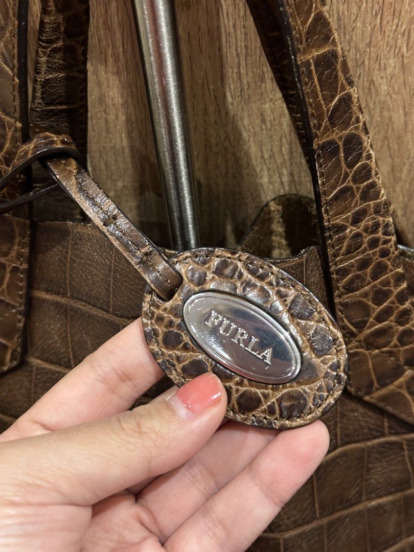 Authentic Furla Jucca Bag in Brown Leather (Category: Luxury Bags & Wallets) located in Makati City. Submitted by sarahgscloset (Listing ID 1449541392, Image 2). Description: - Well-loved authentic Furla Jucca Tote - Bought in Spain back in 2016 - Comes with Dust Bag - Price is negotiable RFS: Decluttering.