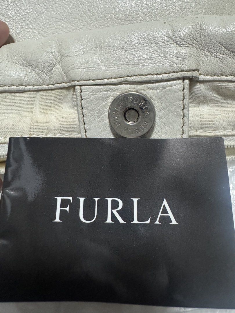 Furla White Leather Braided Handle Shoulder Bag (Category: Luxury Bags & Wallets) located in Quezon City. Submitted by TGDL123 (Listing ID 1442875790, Image 2). Description: - Authentic Furla white leather shoulder bag - Features stylish braided handles - Elegant metal tag with Furla logo - Soft, slouchy leather texture - Ample interior space for essentials - Ideal for everyday wear -Vintage Preloved.